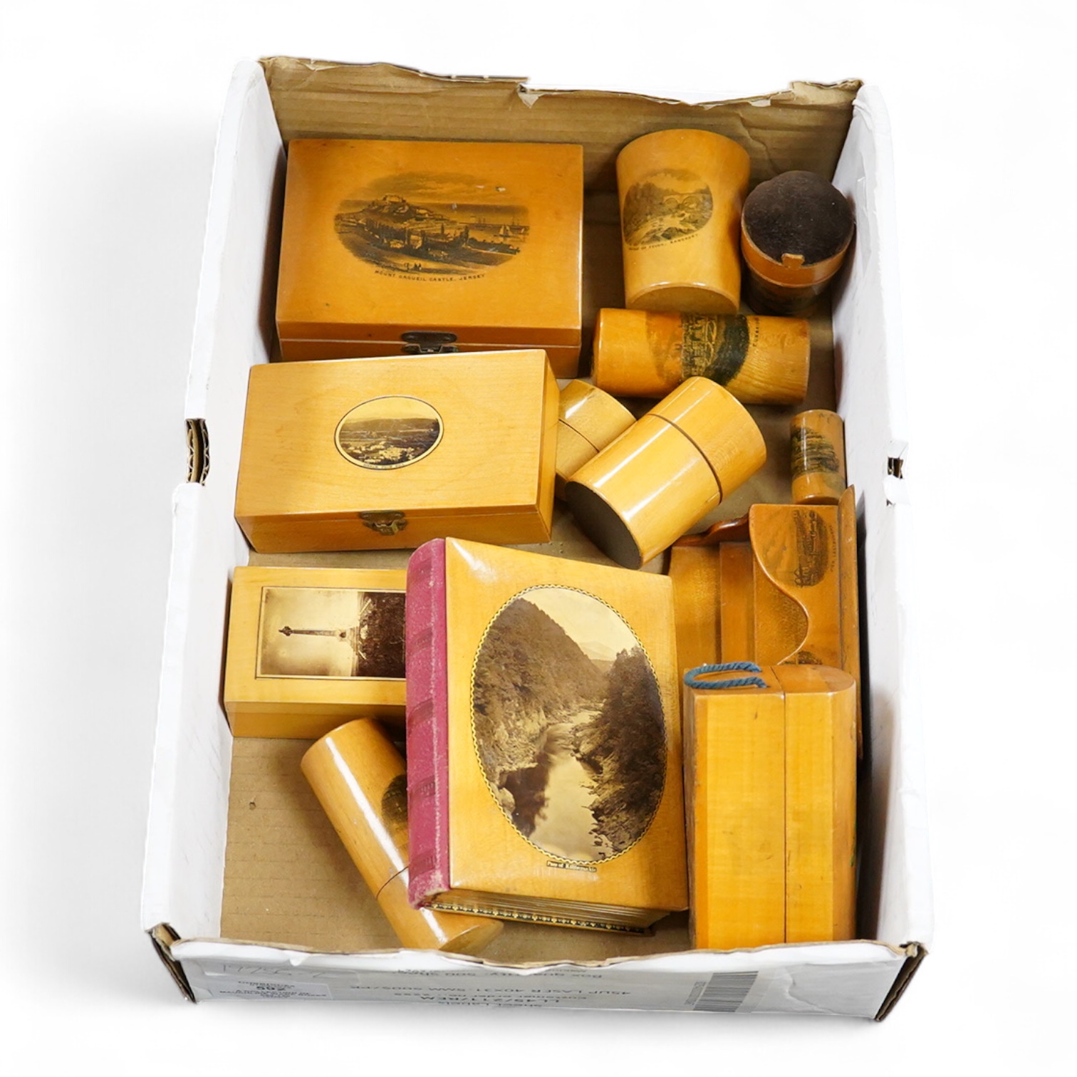 A collection of Scottish mauchline ware boxes, a pin cushion, beaker and a photo frame containing black and white topographical photos